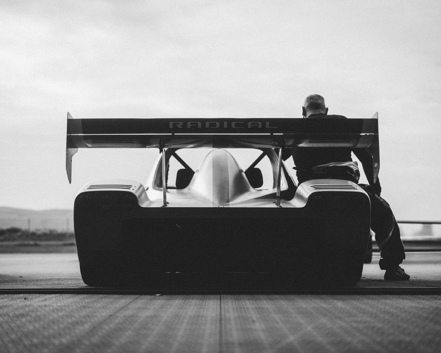 Radical race car from behind with driver